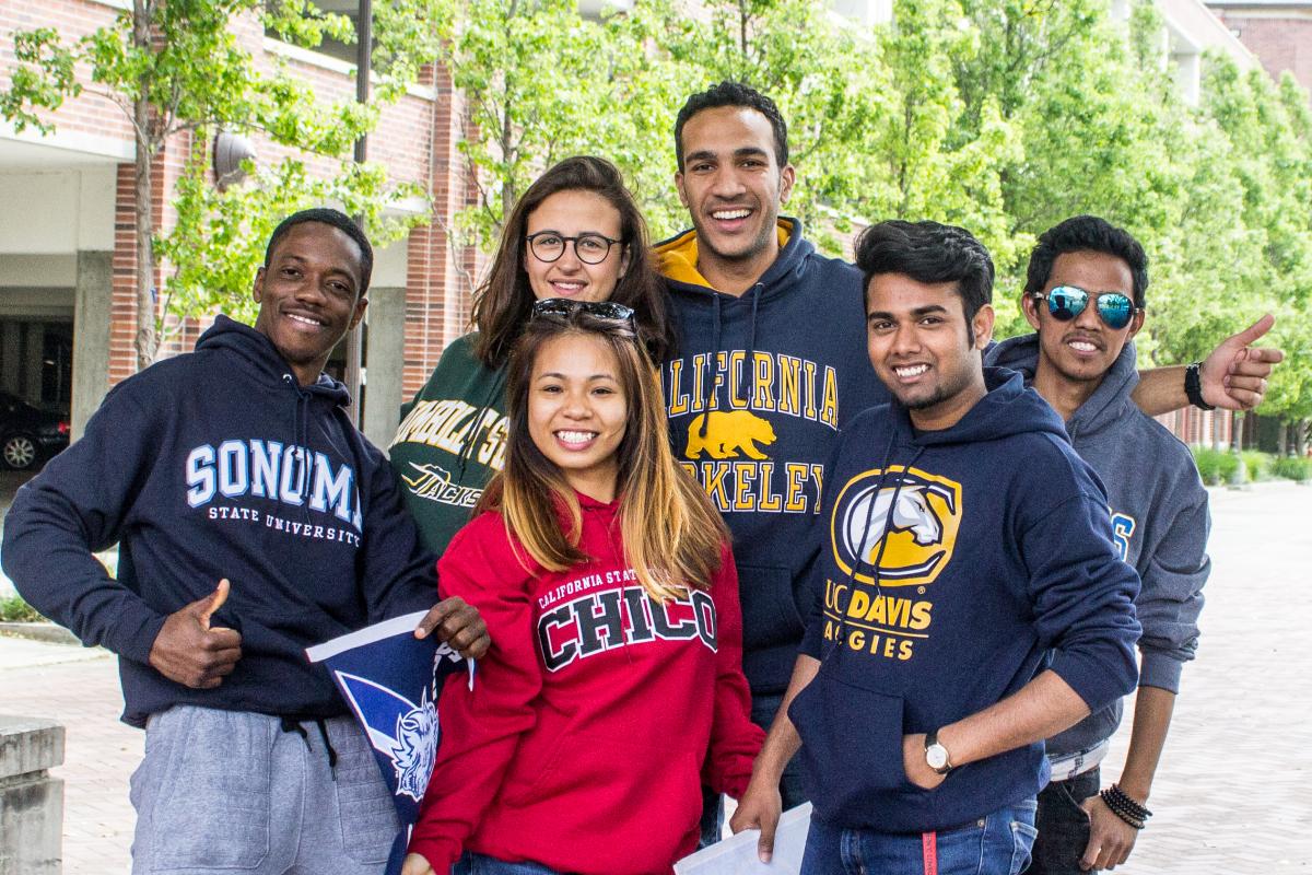 Students wearing different university sweatshirts