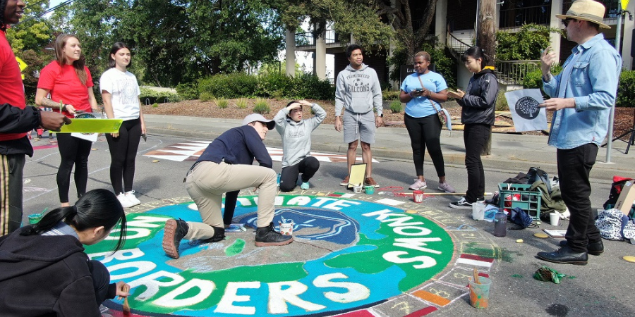 Students painting a mural on Elliot Ave