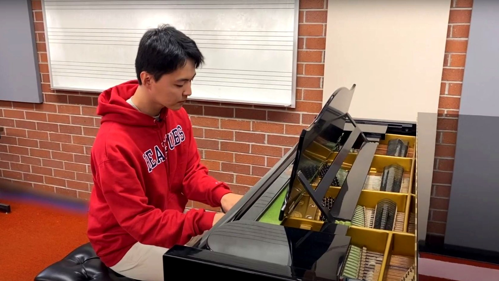 Music students performing together with a variety of instruments during class.
