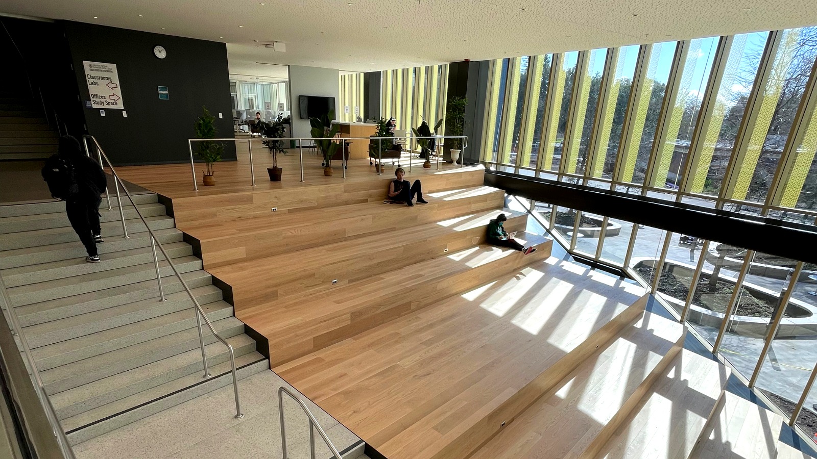 The interior of an SRJC building featuring large wooden steps used as seating and study space.