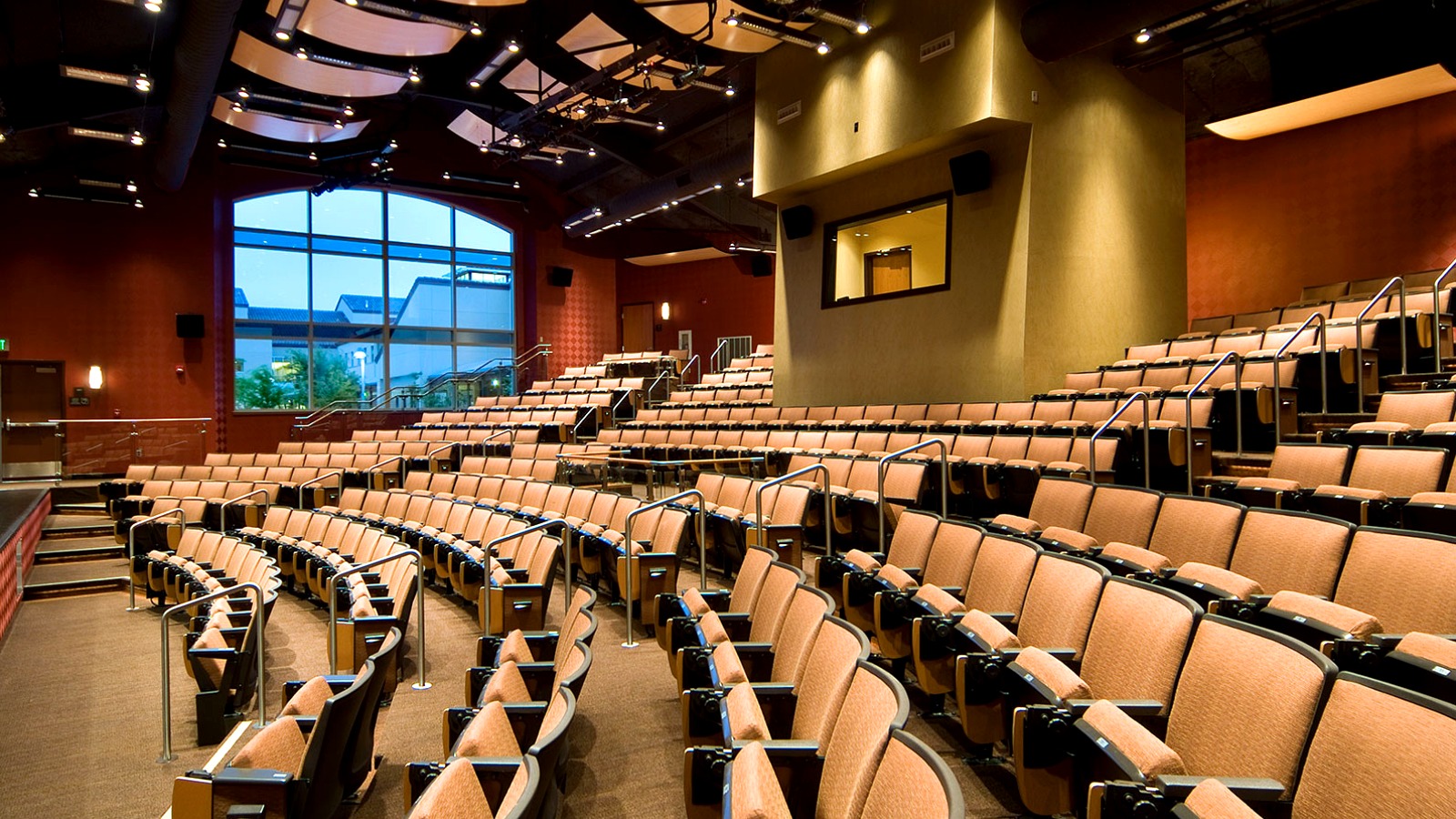 The main theater space on the SRJC Petaluma campus with warm lighting and curved seating.