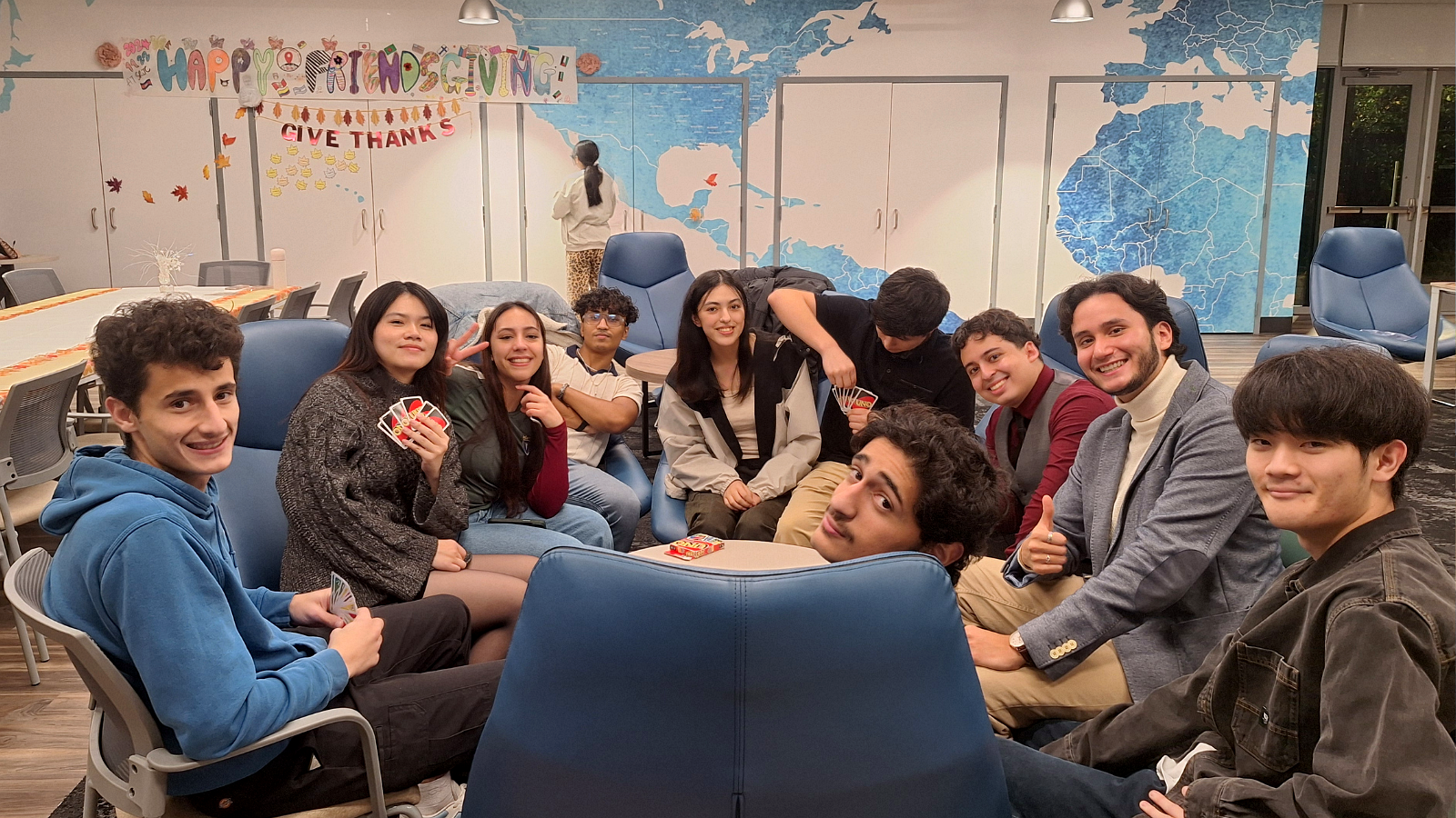 A large group of students gathered in the residence hall’s bright and comfortable great room.